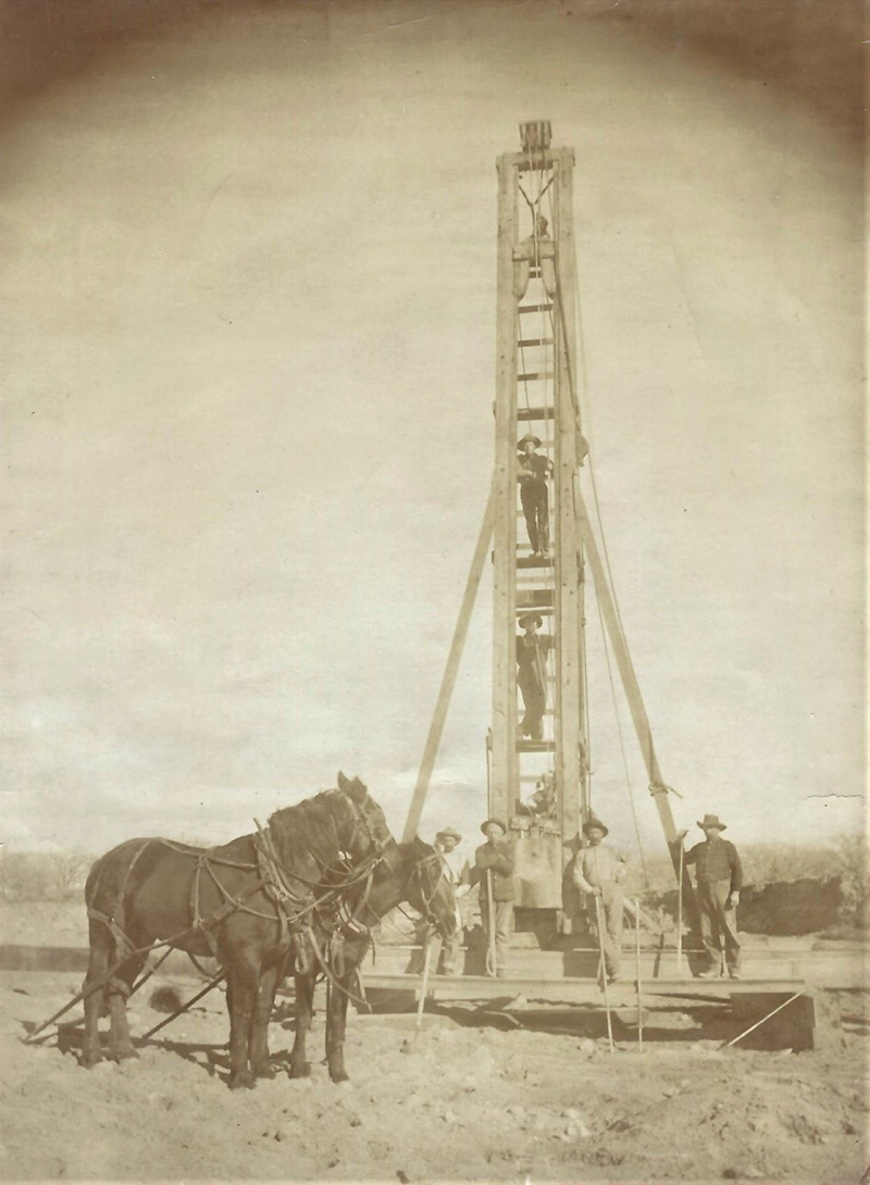 pile driver is used to construct flumes along the canal routes with workers and a horse team surrounding it