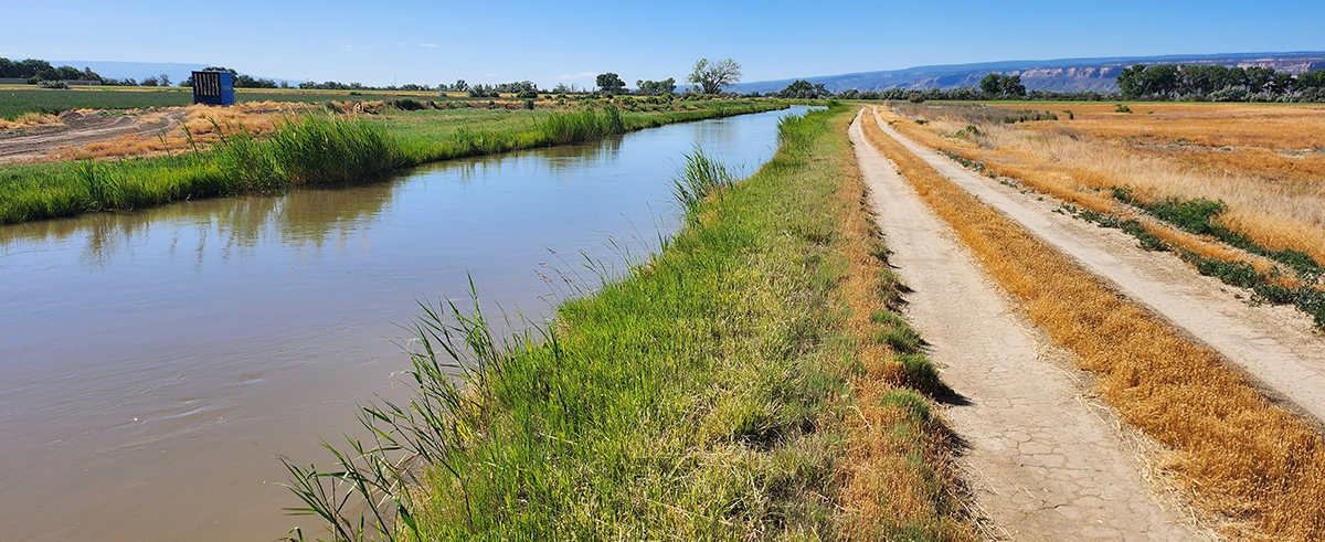 grand valley irrigation water canal and dirt road